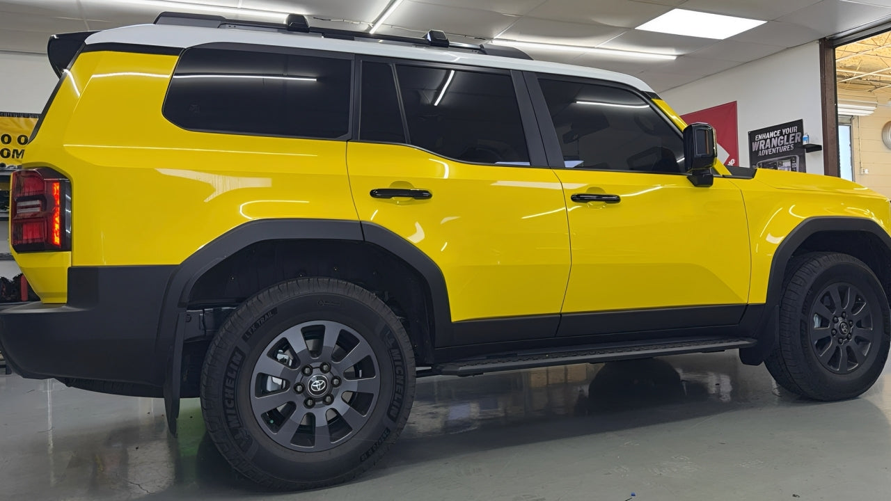 High-quality ceramic window tint installation on a yellow Toyota SUV performed at Houston Car Stereo. Dark, heat-rejection tint ideal for Texas weather, providing UV protection and privacy.