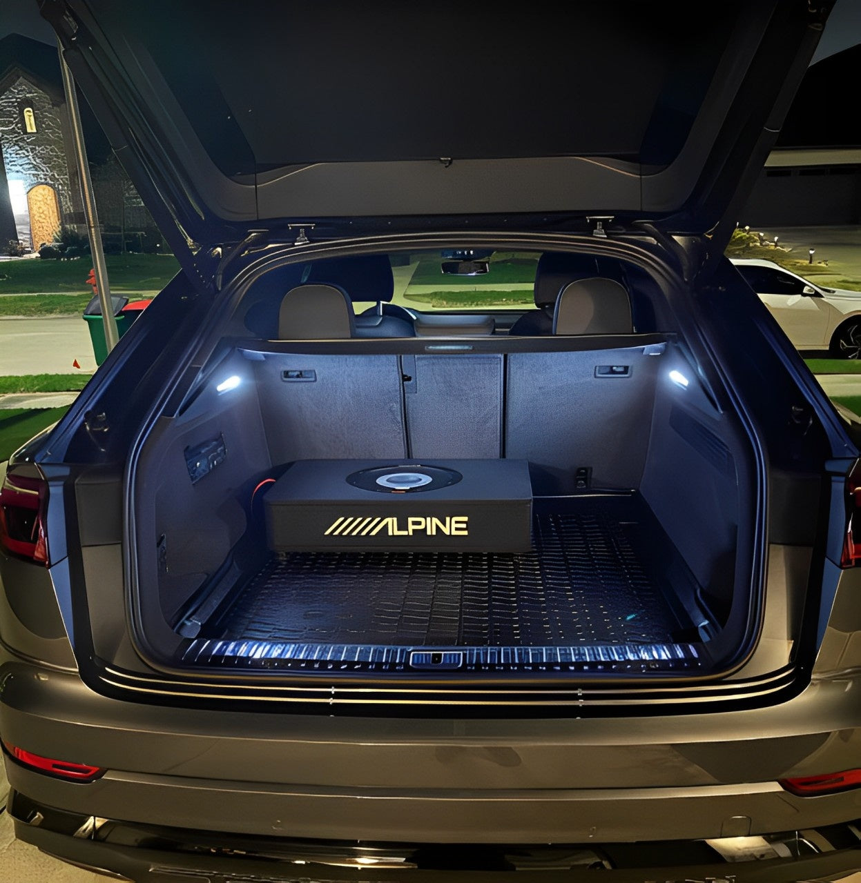 Custom Alpine powered subwoofer installed in the trunk of a luxury SUV at Houston Car Stereo. Clean wiring, OEM-style setup, and enhanced bass performance.