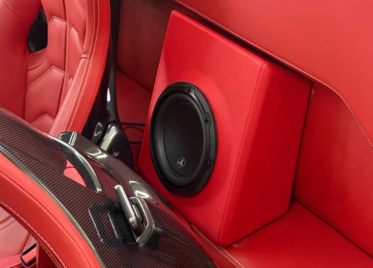 Custom JL Audio subwoofer installation in a Ferrari by Houston Car Stereo. High-end car audio installation with custom fabrication, premium bass, factory-style integration, amplifier and speaker upgrades for exotic and luxury vehicles. Houston car audio and custom car stereo installation for Ferrari, Porsche, BMW, Mercedes, Lexus, Range Rover, trucks, and SUVs.